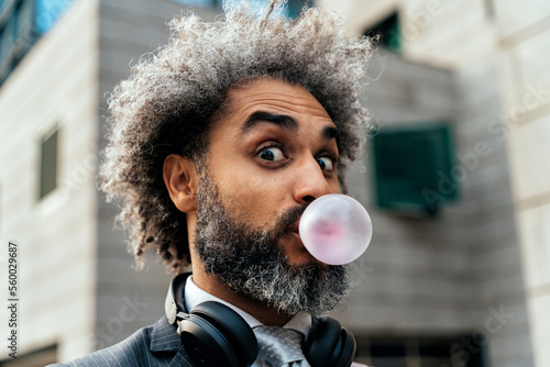 Slika na platnu Young entrepreneur chewing fruit bubble gum