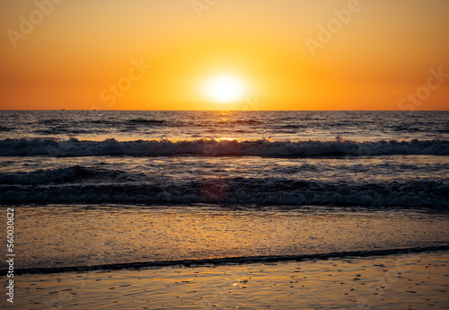 Beautiful sunset over the sea. Rays of the sun touches surface of the calm sea. Meditative atmosphere.