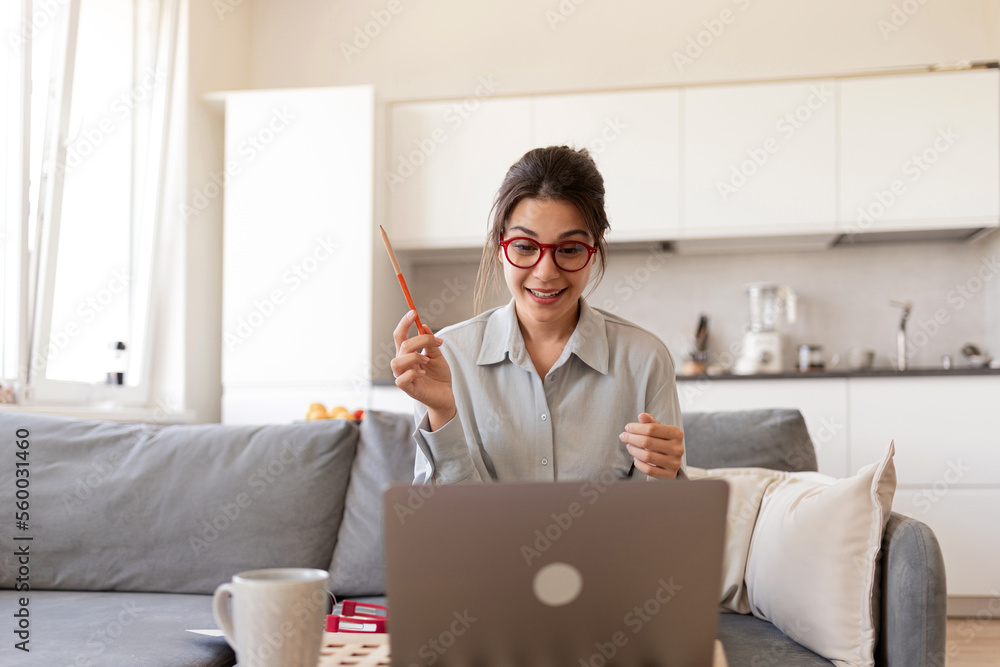 A teacher leads a lesson in an online school, explaining the topic of the lesson. A young woman works as an online teacher from home. A teacher leads a lesson in an online school, explaining the topic of the lesson. A young woman works as an online teacher from home.