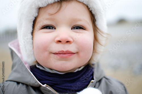 Portrait of a cute little girl on the beaches of northern France in winter