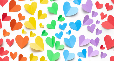 
seamless pattern composition with rainbow colored paper hearts on a white background. concept of valentine's day, lgbt, pride month. copy space. flat lay. top view.