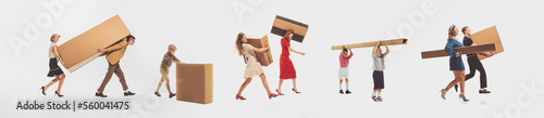 Group of young happy people in vintage clothes carrying big cardboard boxes isolated over white studio background. Black Friday, sales, shopping, moving, real estate concept.