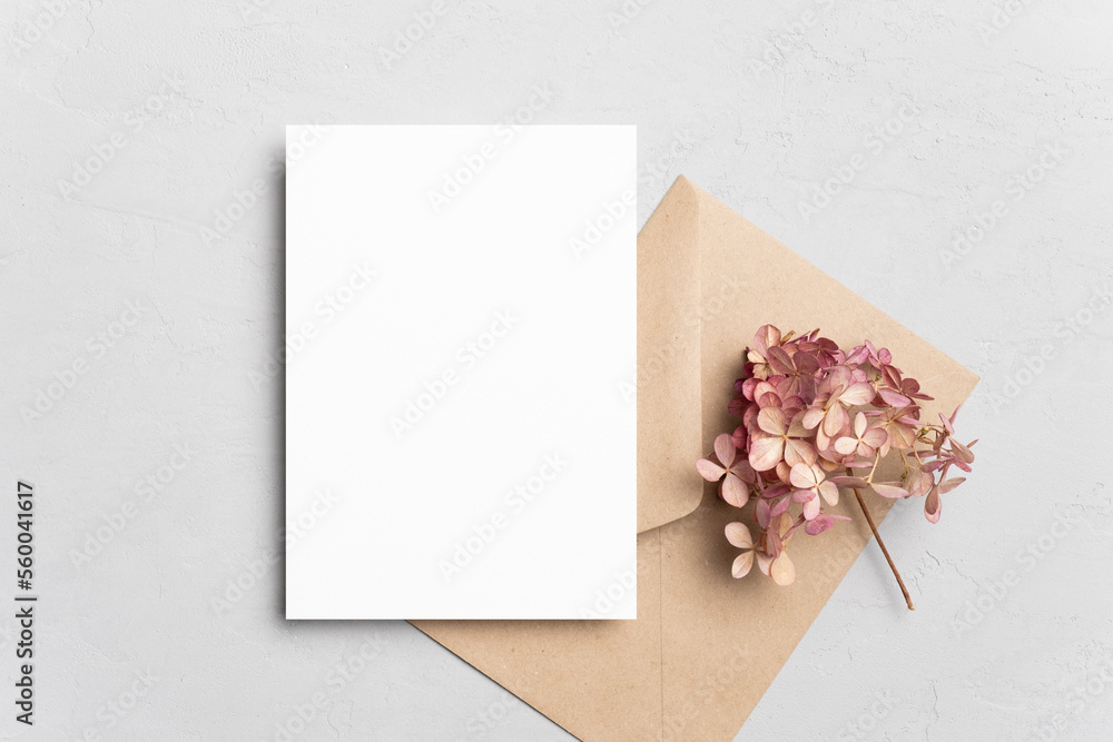 Blank invitation or greeting card mockup with flowers and envelope, wedding card flat lay Blank invitation or greeting card mockup with flowers and envelope, wedding card flat lay