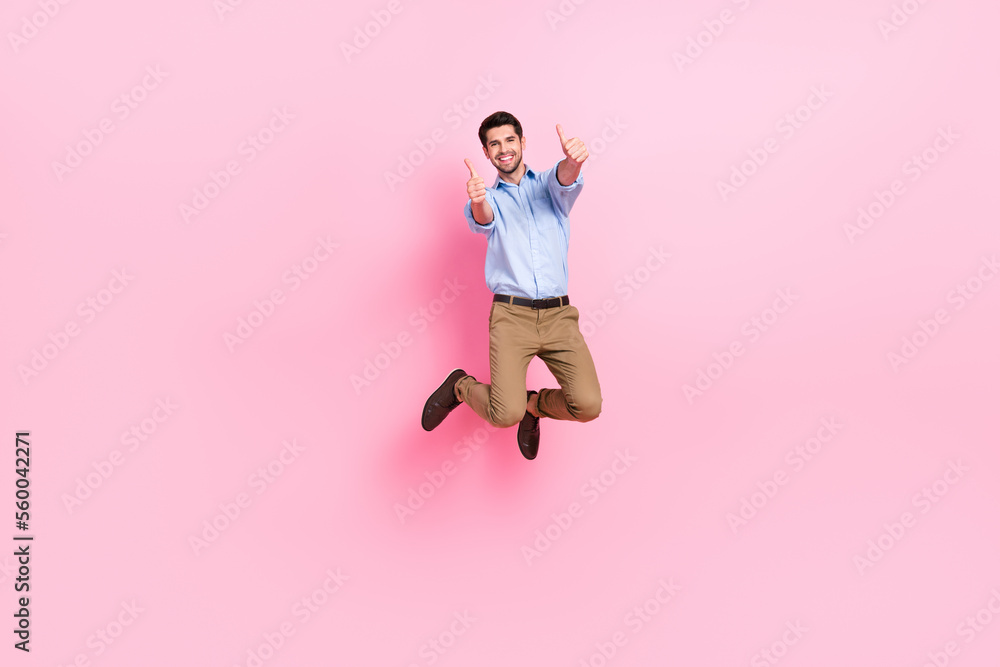 Full length photo of young jump air excited positive guy wear formal outfit thumbs up enjoy new google office job isolated on pink color background