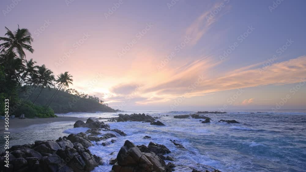 Sunrise over the beach on a tropical island. Exotic seascape with coconut palms. Tourist destination - Sri Lanka. High quality 4k footage Sunrise over the beach on a tropical island. Exotic seascape with coconut palms. Tourist destination - Sri Lanka. High quality 4k footage