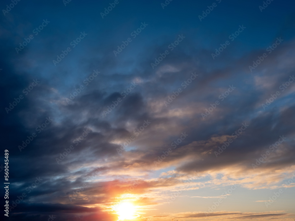 Beautiful cloudy sky with rich blue color at sunset. Nature background for design and sky replacement.
