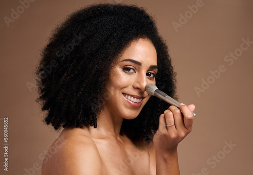 Black woman, studio portrait and brush for foundation, beauty or cosmetic self care by backdrop with smile. Model, happy and powder makeup for face, skincare glow or application by studio background
