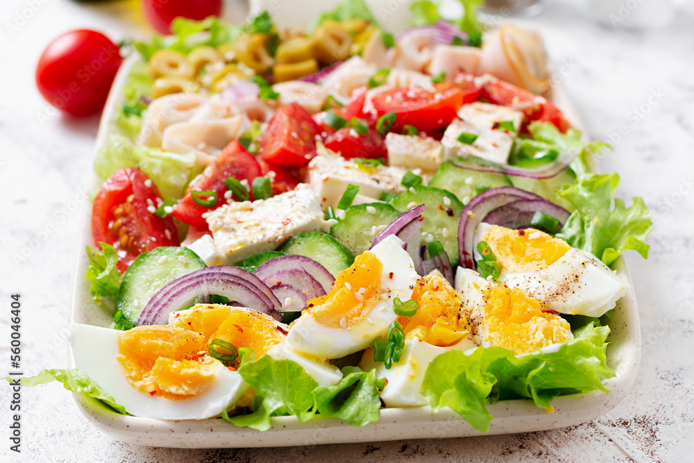 Healthy cobb salad with ham, cucumber, tomato, olives, feta cheese and eggs. Ketogenic lunch. Healthy cobb salad with ham, cucumber, tomato, olives, feta cheese and eggs. Ketogenic lunch.
