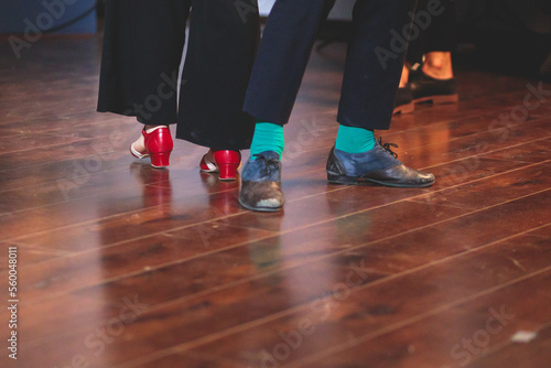 Dancing shoes of young couple dance retro jazz swing dances on a ballroom club wooden floor, close up view of shoes, female and male, dance lessons class rehearsal