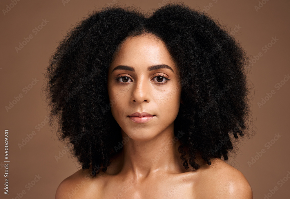 Face, skincare and afro with a model black woman in studio on a brown background for natural beauty. Portrait, cosmetics and hair with an attractive young female posing to promote a cosmetic product Face, skincare and afro with a model black woman in studio on a brown background for natural beauty. Portrait, cosmetics and hair with an attractive young female posing to promote a cosmetic product