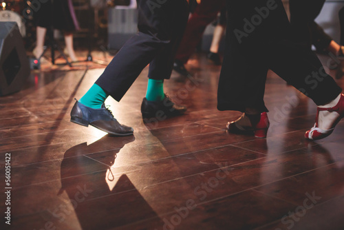 Dancing shoes of young couple dance retro jazz swing dances on a ballroom club wooden floor, close up view of shoes, female and male, dance lessons class rehearsal