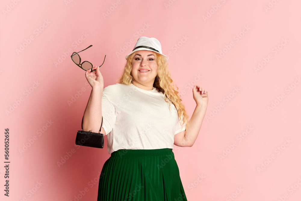 Portrait of stylish woman posing with positive mood over pink studio background. Modern fashion Portrait of stylish woman posing with positive mood over pink studio background. Modern fashion