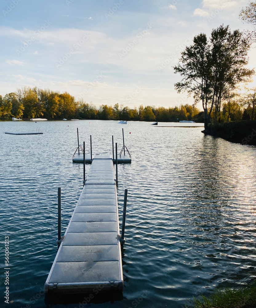 Obraz premium View of Lake Buzerens, Bram, France. Wooden pier on a sunny day.