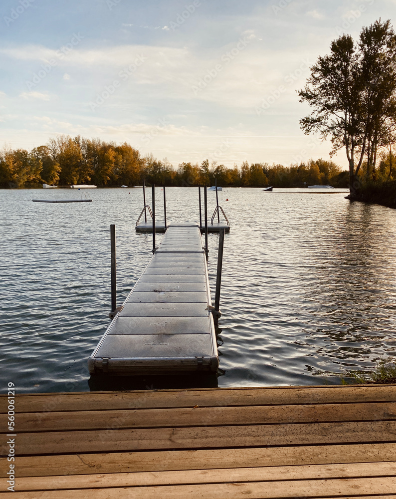 Obraz premium View of Lake Buzerens, Bram, France. Wooden pier on a sunny day.