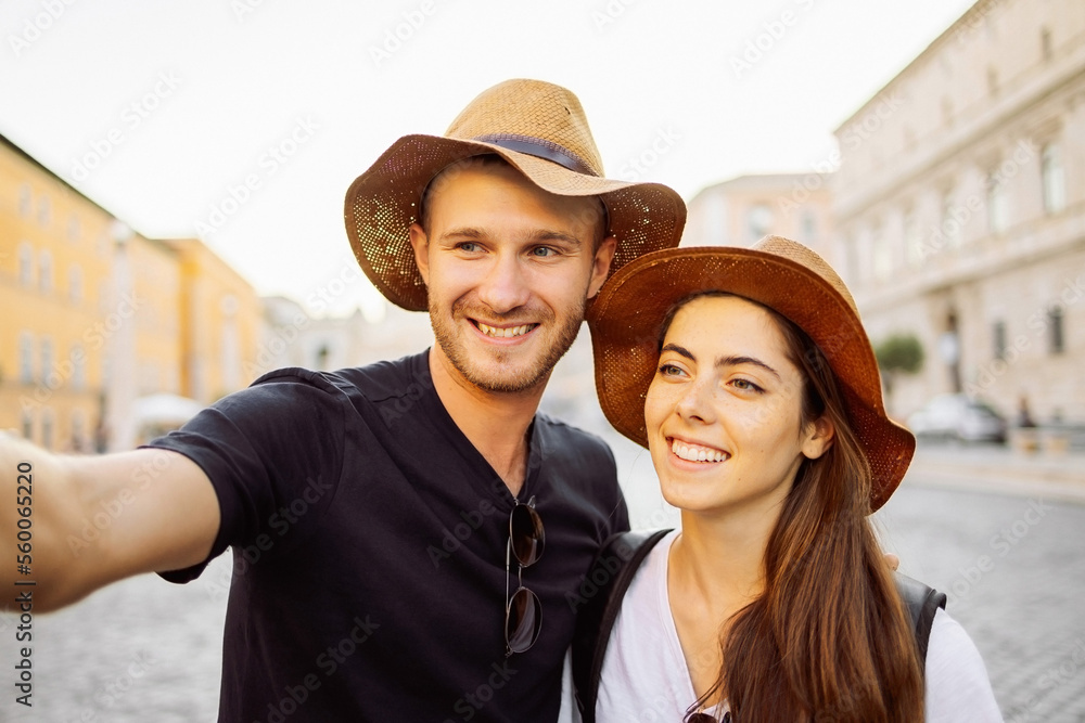 Happy Young couple taking selfie portrait with smartphone mobile outdoor. Tourism, friendship, youth and weekend activities concept. Close up portrait. Tourism, selfie photos, bloggers