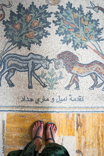 rom the view point of a traveler looking down at an Arabic mosaic on the floor of a church at the baptism site of Jesus Christ in Jordan photo