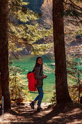 Nice Girl traveller descends to mountain lake photo