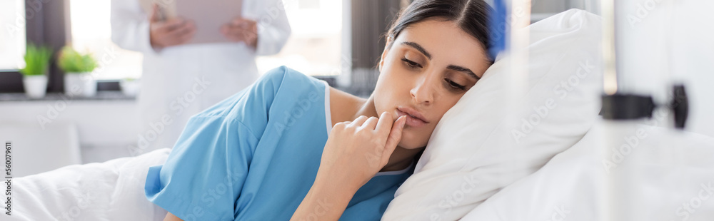 Upset and brunette patient lying on hospital bed, banner. Upset and brunette patient lying on hospital bed, banner.