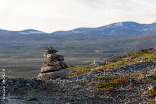 mountain landscape that can be seen from the viewpoint Snøhetta in Dovre Municipality with a cairn in the foreground photo