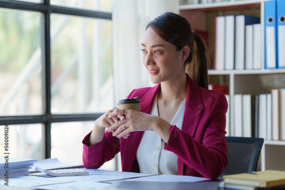 Asian Business woman working at home office and analyze financial report document. Accounting and Finance concept Asian Business woman working at home office and analyze financial report document. Accounting and Finance concept