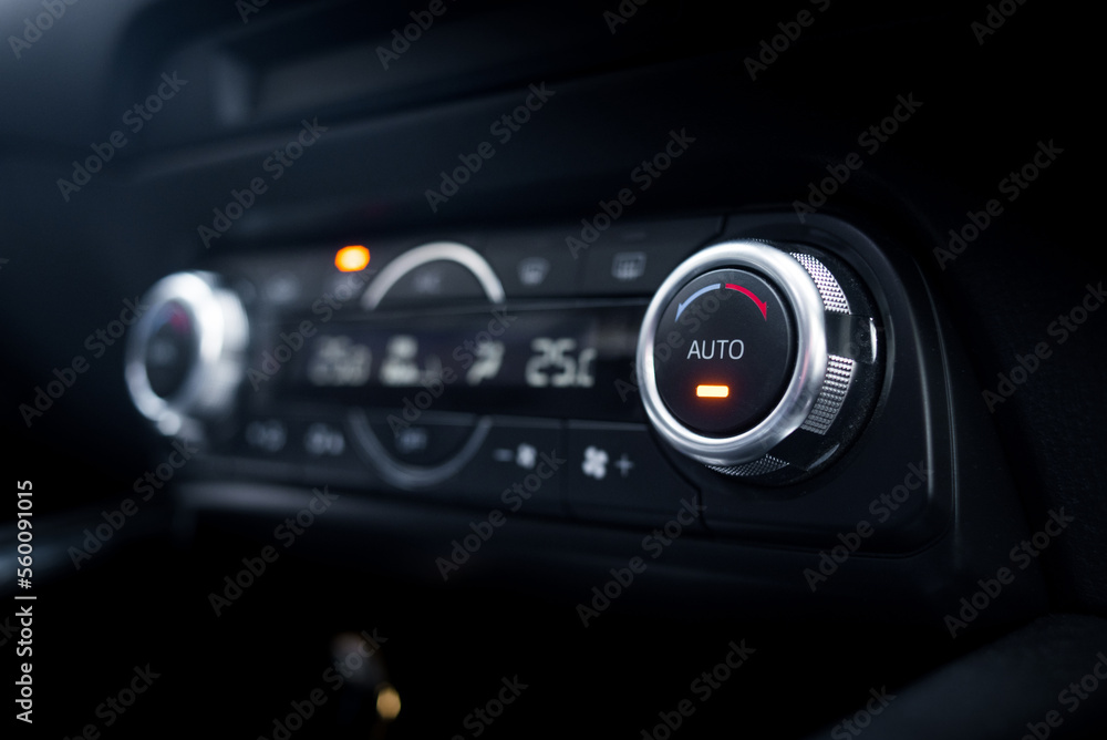 Close up auto air conditioning adjustment button.
Car air conditioning control unit with temperature status display.