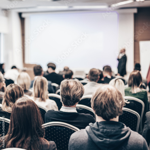 Speaker giving a talk in conference hall at business event. Rear view of unrecognizable people in audience at the conference hall. Business and entrepreneurship concept © kasto
