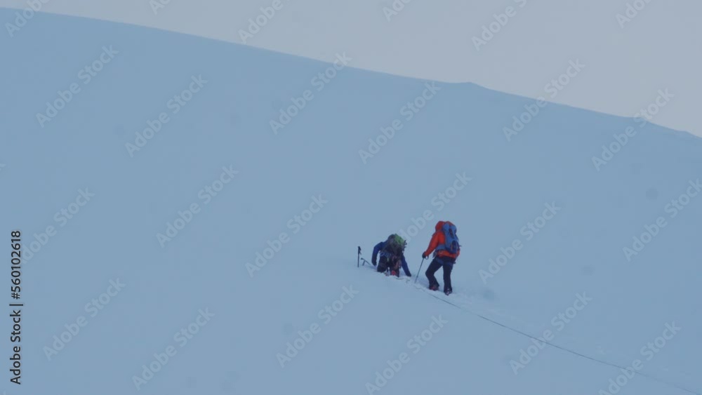 Mountaineers on the top of a snowy mountain Mountaineers on the top of a snowy mountain