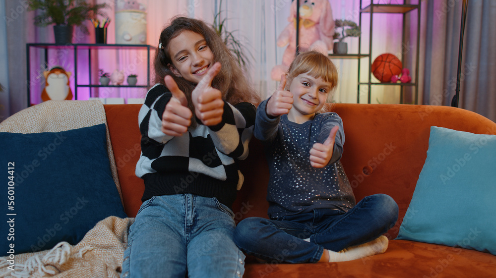 Like. Happy teenage child and little sister kid looking approvingly at camera showing thumbs up, like sign positive something good, positive feedback. Siblings children or friends at home play room Like. Happy teenage child and little sister kid looking approvingly at camera showing thumbs up, like sign positive something good, positive feedback. Siblings children or friends at home play room
