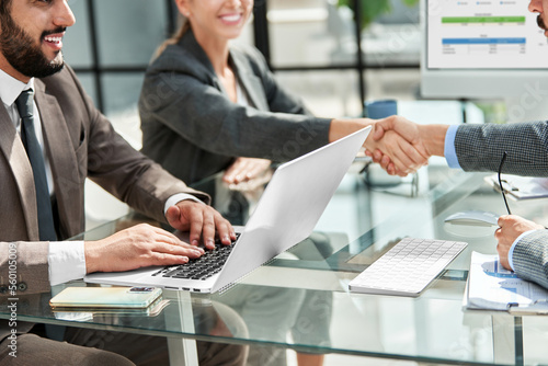 businesswoman shaking hands with her financial partner.
