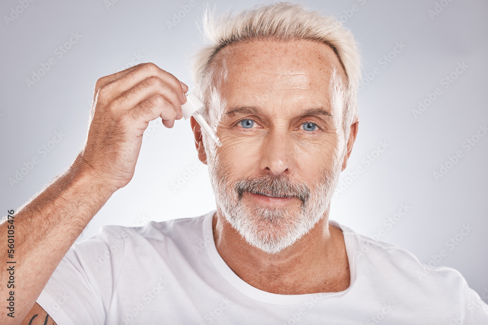 Obraz premium Senior man, facial portrait and oil skincare wellness, cosmetics beauty treatment and dermatology product in white studio background. Luxury spa, rich hyaluronic acid and face wrinkles serum dropper