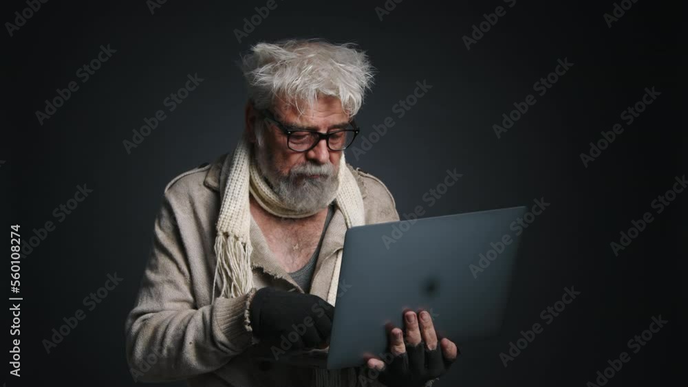 Portrait of caucasian online trader wearing poor, dirty clothes. Close-up shot of adult, homeless man working on his laptop. High quality 4k footage Portrait of caucasian online trader wearing poor, dirty clothes. Close-up shot of adult, homeless man working on his laptop. High quality 4k footage