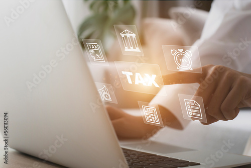 Business using a computer to complete Individual income tax return form online for tax payment with business icon.