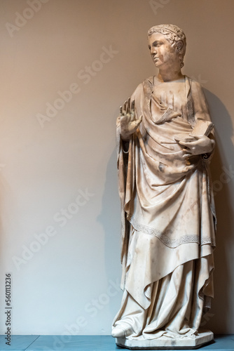 Ancient marble statue of roman man making a gesture of "stop" with his hand