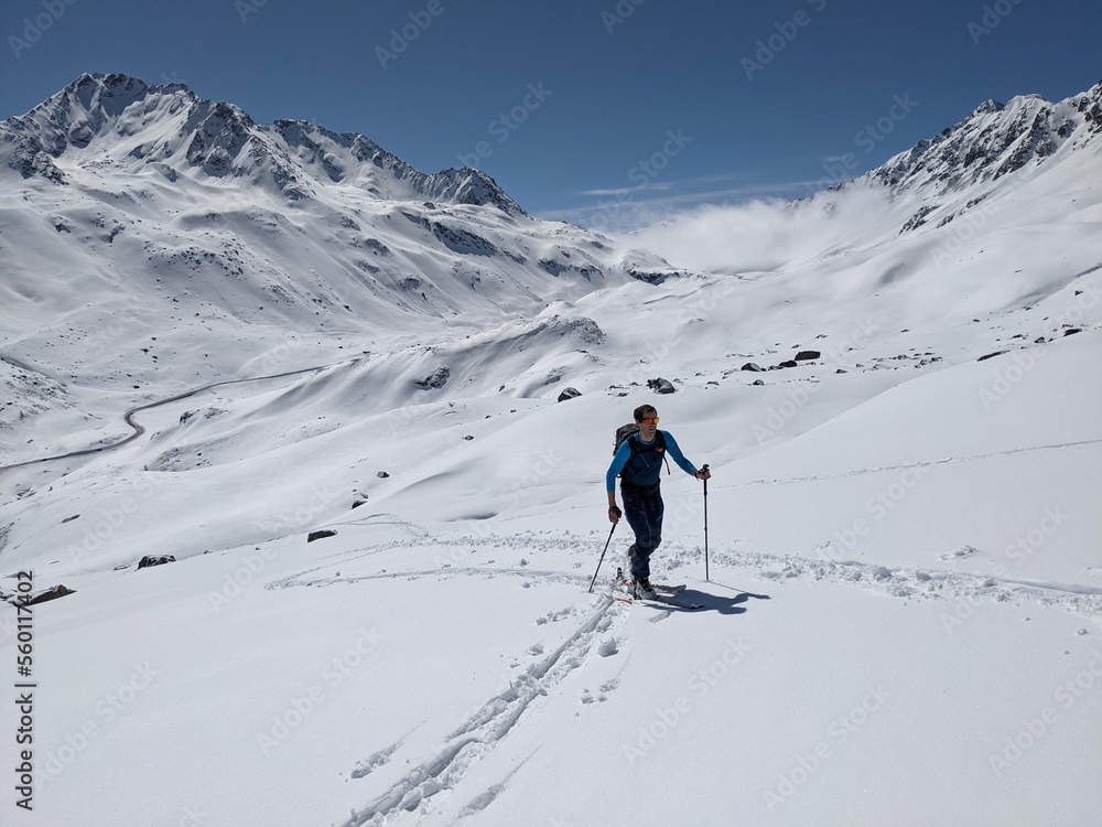 young man on a ski tour while ascending the mountain top.ski mountaineering in a wonderful mountain world in davos swiss