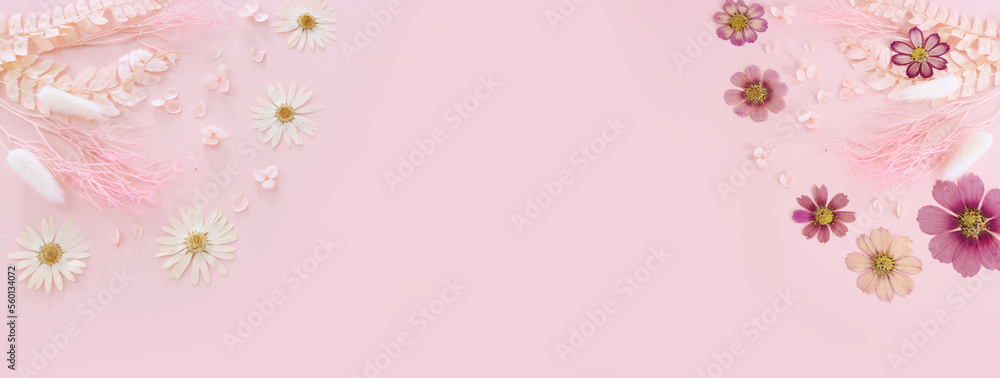 Fototapeta premium Top view image of pink dry flowers over pastel background .Flat lay