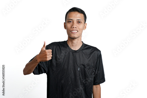 asian man wearing black training t-shirt, feeling happy and giving thumbs up. Isolated by white background