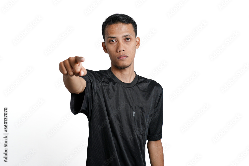 Asian man wearing black training shirt, pointing at you. Isolated by white background Asian man wearing black training shirt, pointing at you. Isolated by white background