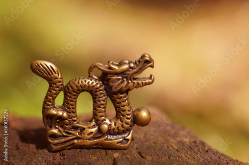 Dragon figurine close-up on a colored background. East Asian culture. A spiritual symbol.
