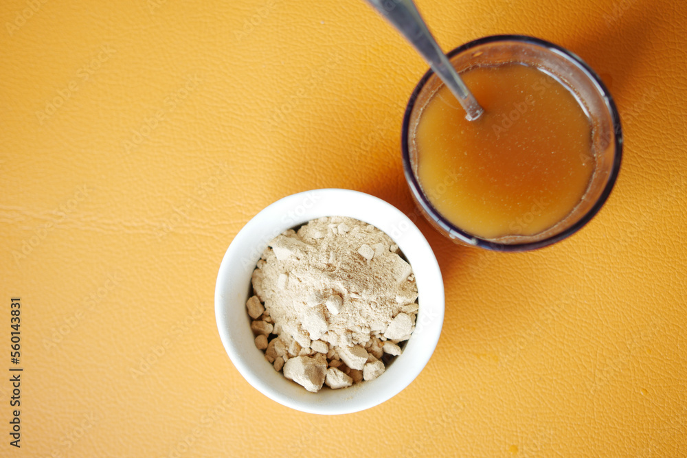 mixing brewers yeast flakes in a glass of water mixing brewers yeast flakes in a glass of water
