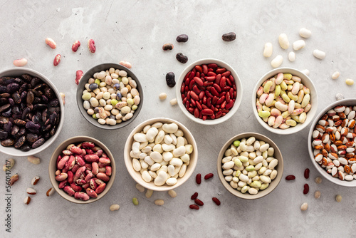 фотографія Different types of beans in bowls, economically important legume, top view, copy
