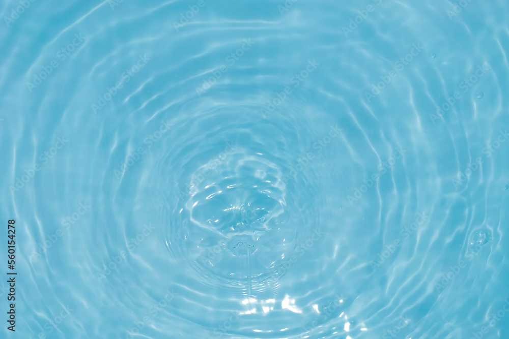 Defocus blurred transparent blue colored clear calm water surface texture with splashes and bubbles. Trendy abstract nature background. Water waves in sunlight with caustics. Blue water shinning Defocus blurred transparent blue colored clear calm water surface texture with splashes and bubbles. Trendy abstract nature background. Water waves in sunlight with caustics. Blue water shinning
