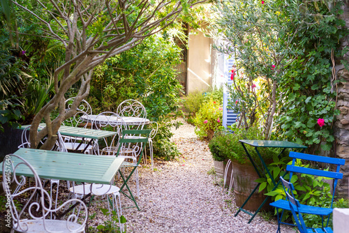 Intimate cafe in the garden at Belle-le-En-Mer in France