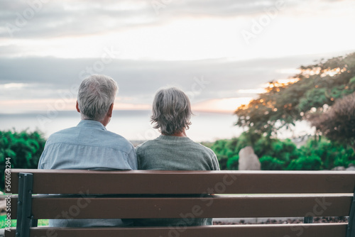 Fotobehang Head shot close up portrait happy grey haired middle aged woman with older husband, enjoying sitting on bench at park