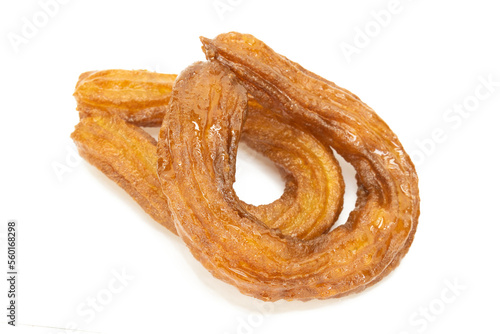 Traditional Turkish dessert (halka tatlı) on isolated white background. Turkish dessert deep fried and dipped in sugar syrup.