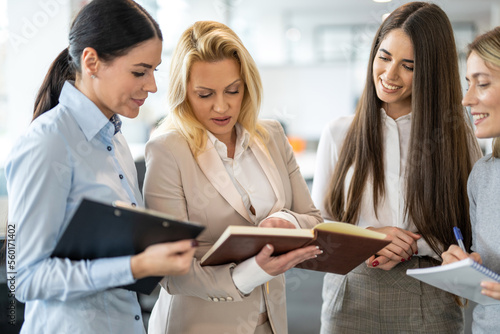 Group of business women reviewing documents at office.