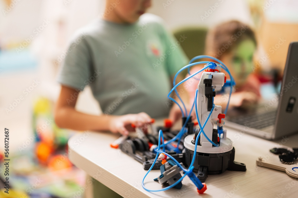 Children learning repairing getting lesson control robot arm, robotic