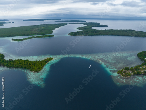 A beautiful coral reef surrounds a scenic bay in the Solomon Islands. This beautiful country is home to spectacular marine biodiversity and many historic WWII sites.