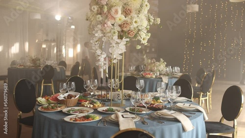 food and drinks on a wedding table in a restaurant with wedding decor
