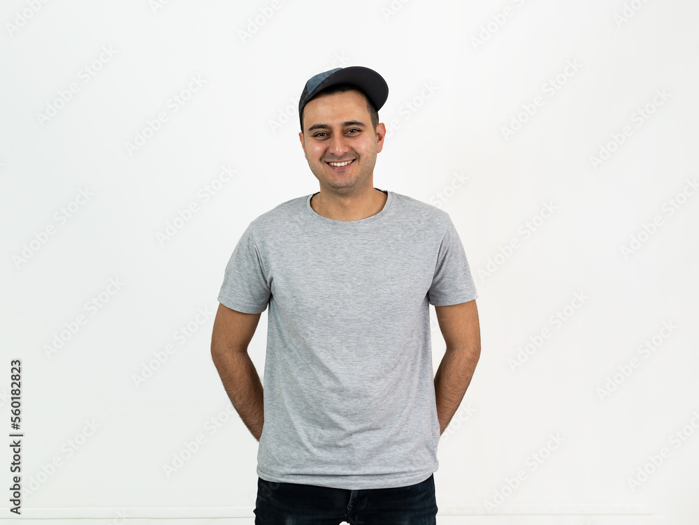 Close up studio photo of brown skinned young adult standing and smiling to camera. Space for text. Close up studio photo of brown skinned young adult standing and smiling to camera. Space for text.