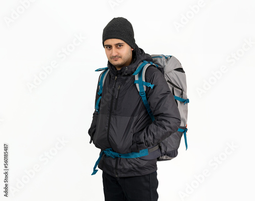 Studio photo of Brown skinned young backpacker, camper or hiker standing on isolated background. Concept of trekking or nature walking.